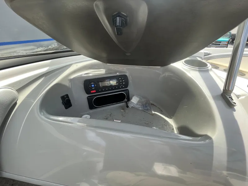 Slide: The Image of 2011 Bayliner 195 boat dashboard with stereo system and storage compartment. - 20