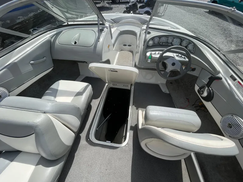 Slide: The Image of Interior of a 2011 Bayliner 195 boat with seating and steering wheel. - 22