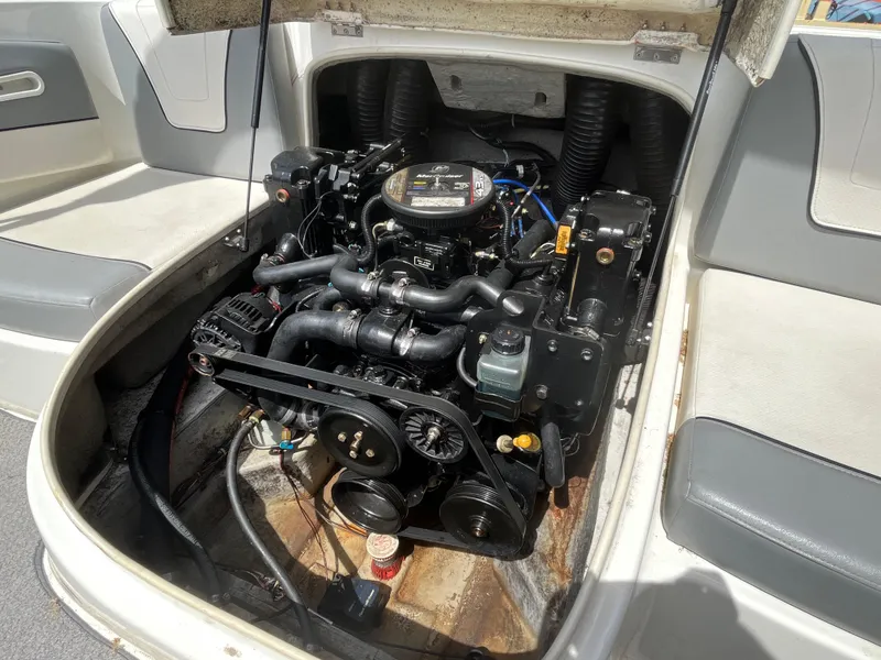 Slide: The Image of 2011 Bayliner 195 boat engine compartment with visible engine components. - 23