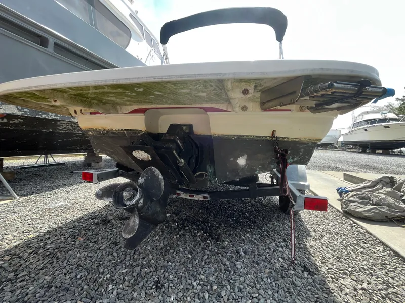 Slide: The Image of 2011 Bayliner 195 boat on trailer, rear view showing propeller and hull. - 7