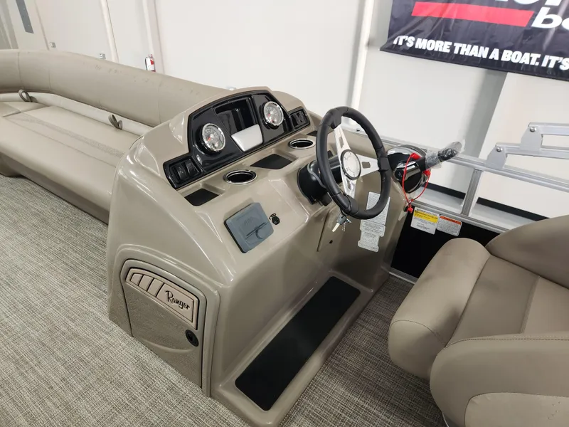 Slide: The Image of 2025 Ranger 200C boat interior with steering console and seating. - 10