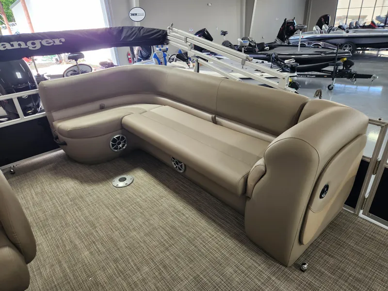 Slide: The Image of 2025 Ranger 200C boat interior with beige seating and built-in speakers. - 11