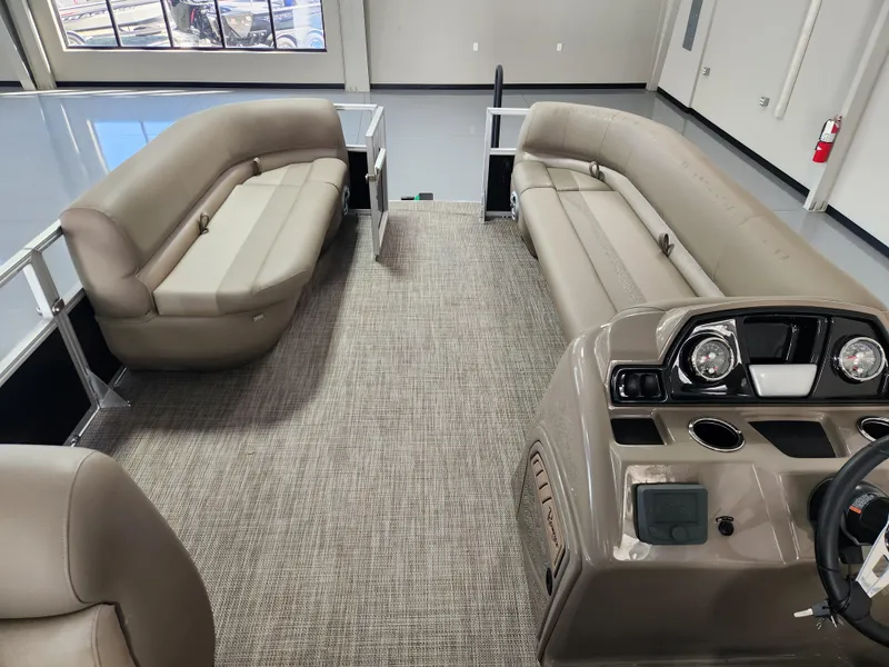 Slide: The Image of Interior of 2025 Ranger 200C pontoon boat with beige seating and modern dashboard. - 13