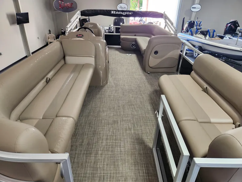 Slide: The Image of 2025 Ranger 200C pontoon boat interior with beige seating and spacious layout. - 15