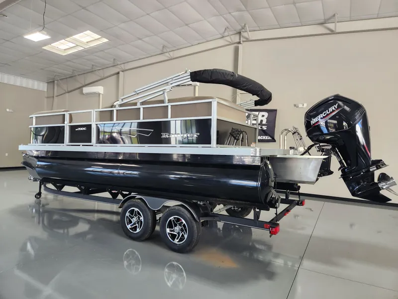 Slide: The Image of 2025 Ranger 200C pontoon boat with Mercury outboard motor in showroom. - 2