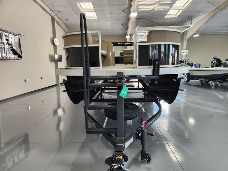 Slide: The Image of 2025 Ranger 200C pontoon boat on trailer in showroom, featuring sleek design and modern amenities. - 7
