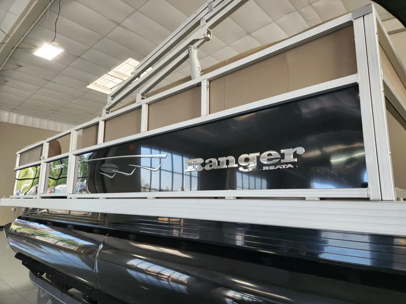 Slide: The Image of 2025 Ranger 200C pontoon boat displayed indoors, showcasing sleek design and branding. - 9