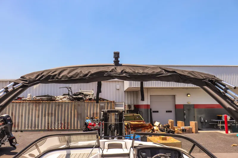 Slide: The Image of 2025 Yamaha Boats AR195 with wakeboard tower in a storage yard. - 19