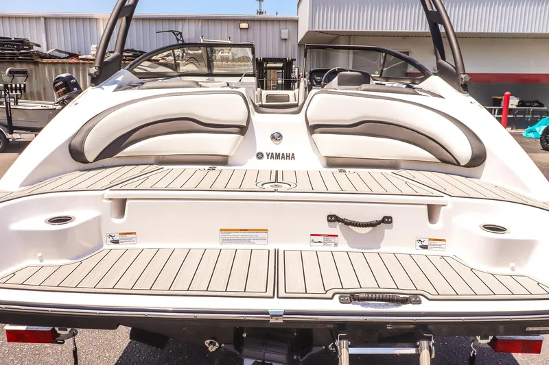 Slide: The Image of 2025 Yamaha Boats AR195, rear view, showcasing sleek design and spacious seating. - 20