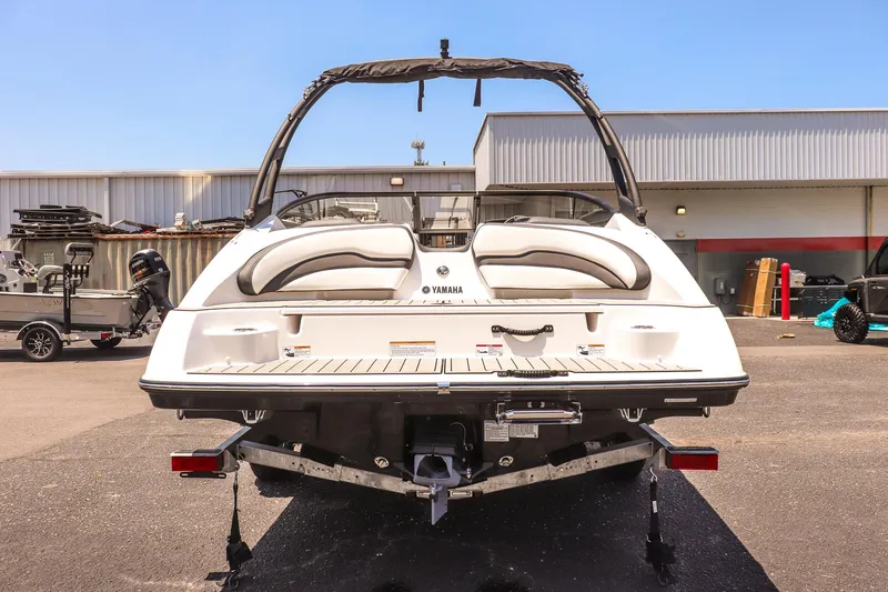 Slide: The Image of 2025 Yamaha AR195 boat, rear view, parked outdoors, showcasing sleek design and modern features. - 4