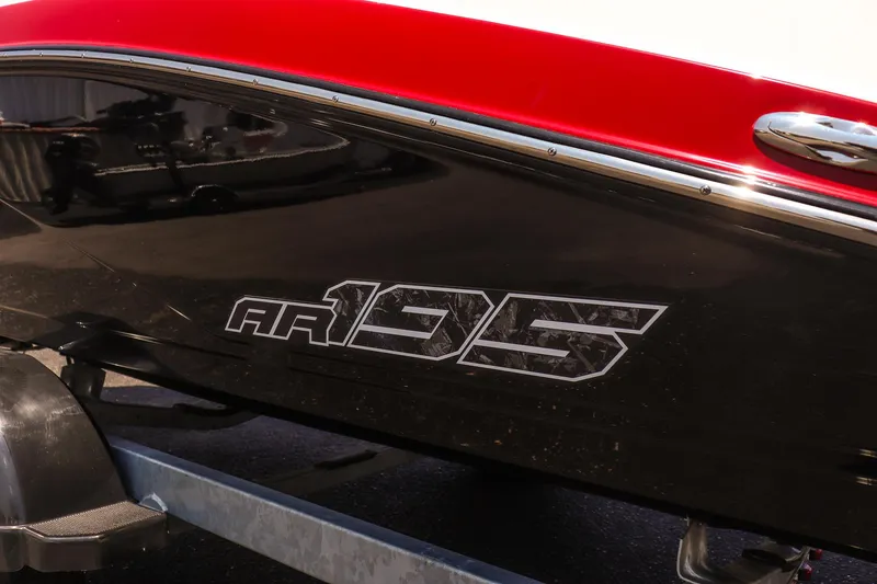 Slide: The Image of 2025 Yamaha Boats AR195 with sleek black and red design on trailer. - 8