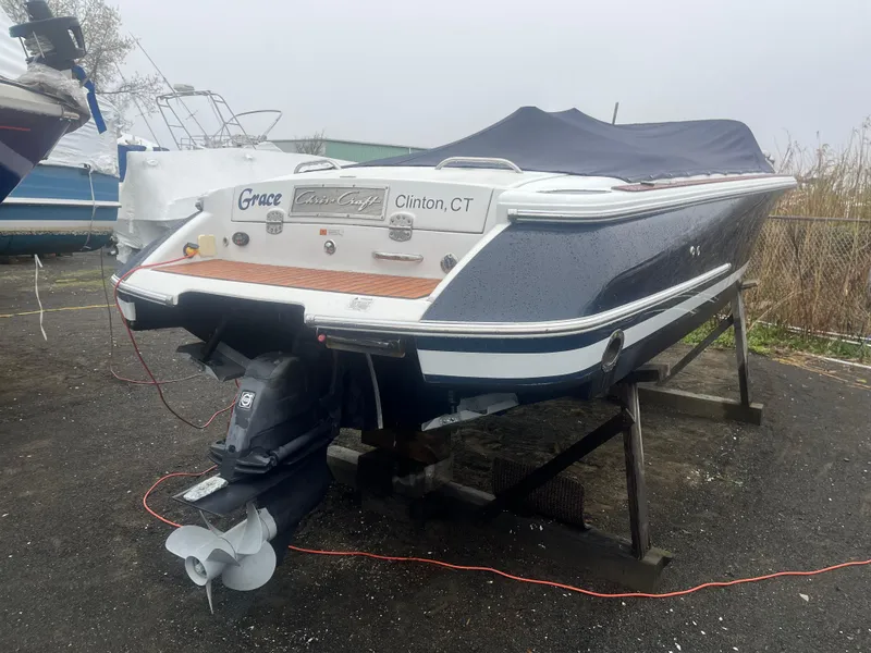 The Image of 2004 Chris-Craft Corsair 25 boat on stand, rear view, covered, Clinton, CT. - 0