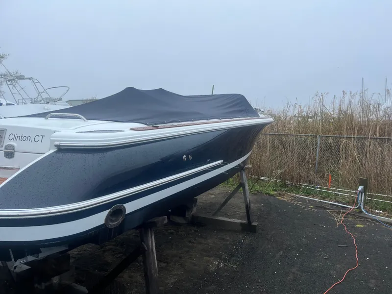 Slide: The Image of 2004 Chris-Craft Corsair 25 boat covered and docked in Clinton, CT. - 2