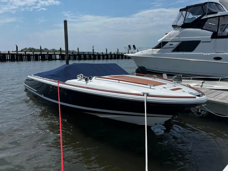 Slide: The Image of 2004 Chris-Craft Corsair 25 boat docked in marina, covered with blue tarp. - 4