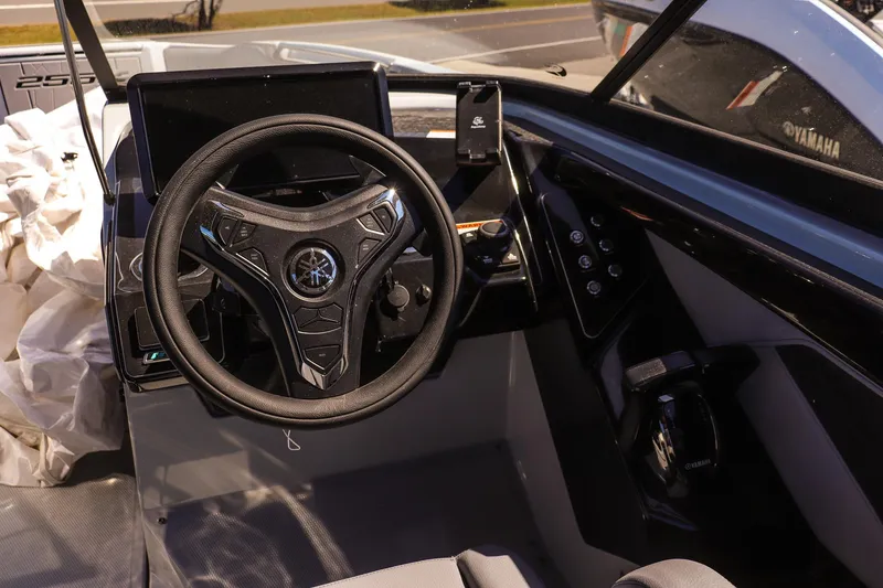 Slide: The Image of 2025 Yamaha Boats 255XD steering console with modern controls and sleek design. - 12