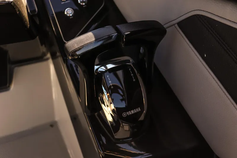 Slide: The Image of Close-up of 2025 Yamaha Boats 255XD throttle control in sleek black design. - 13