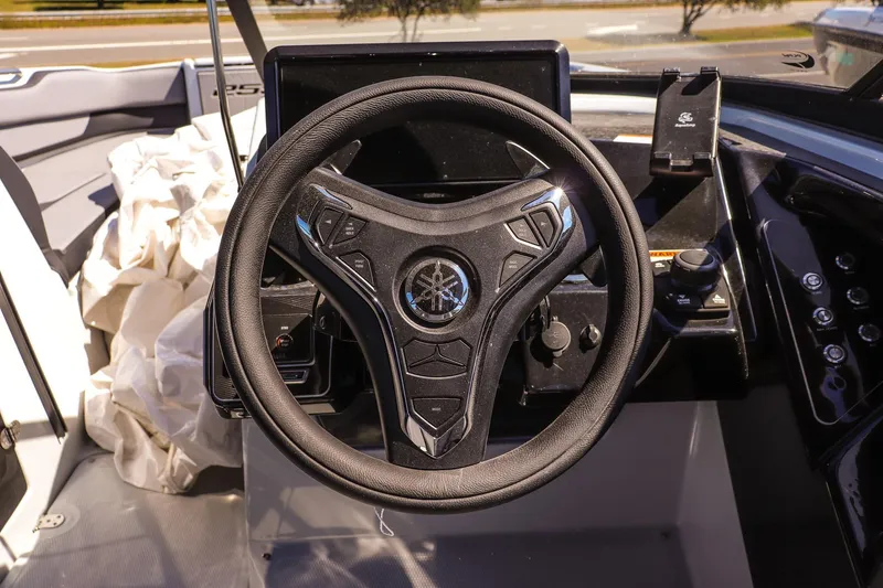 Slide: The Image of Steering wheel of 2025 Yamaha Boats 255XD, featuring modern dashboard controls. - 14