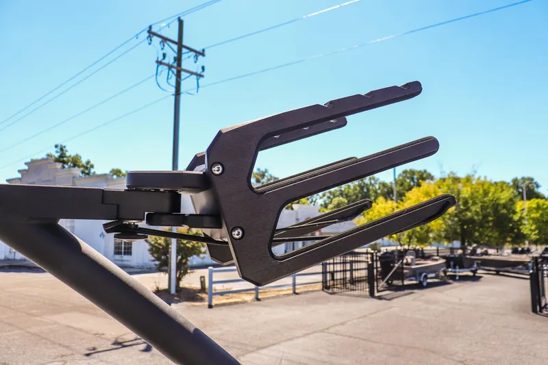 Slide: The Image of Wakeboard rack on 2025 Yamaha Boats 255XD, outdoor setting, clear sky background. - 18