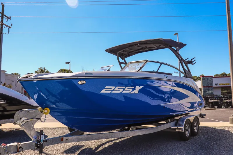 Slide: The Image of 2025 Yamaha Boats 255XD in blue on trailer, displayed outdoors under clear sky. - 3
