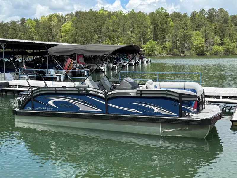 The Image of 2025 JC Neptoon Sport 23TT DSL pontoon boat docked on a serene lake. - 1