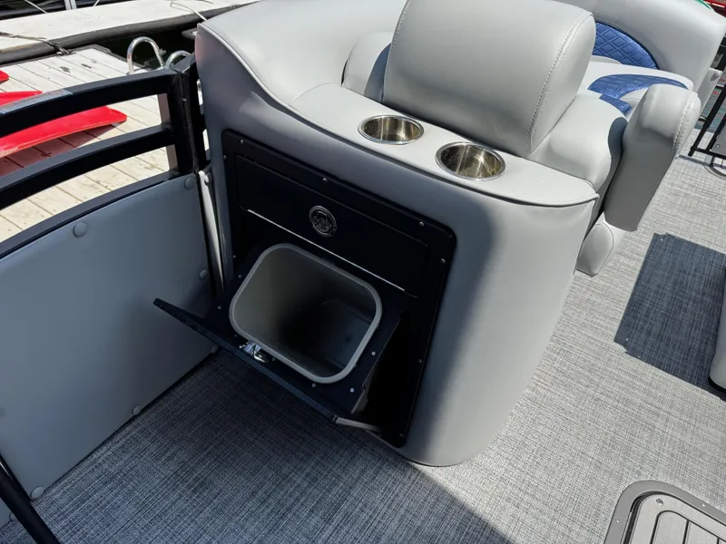 Slide: The Image of 2025 JC Neptoon Sport 23TT DSL boat interior with cup holders and storage compartment. - 10