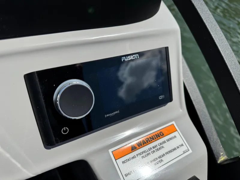 Slide: The Image of Control panel of 2025 JC Neptoon Sport 23TT DSL boat with Fusion audio system. - 19