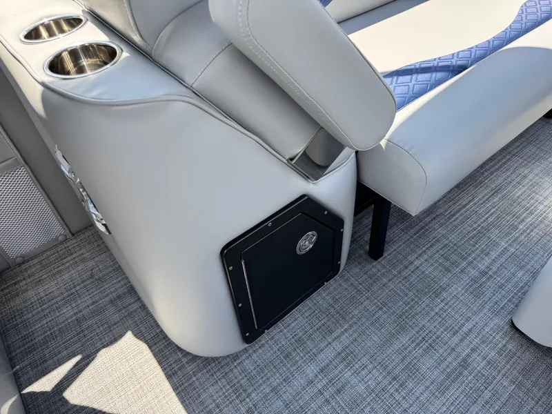 Slide: The Image of 2025 JC Neptoon Sport 23TT DSL boat interior with gray seating, cup holders, and textured flooring. - 23