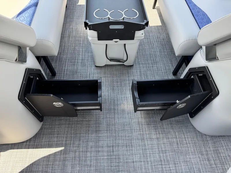 Slide: The Image of 2025 JC Neptoon Sport 23TT DSL interior with open storage compartments and seating. - 24