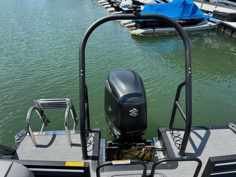 Slide: The Image of 2025 JC Neptoon Sport 23TT DSL pontoon boat with Suzuki outboard motor at dock. - 25