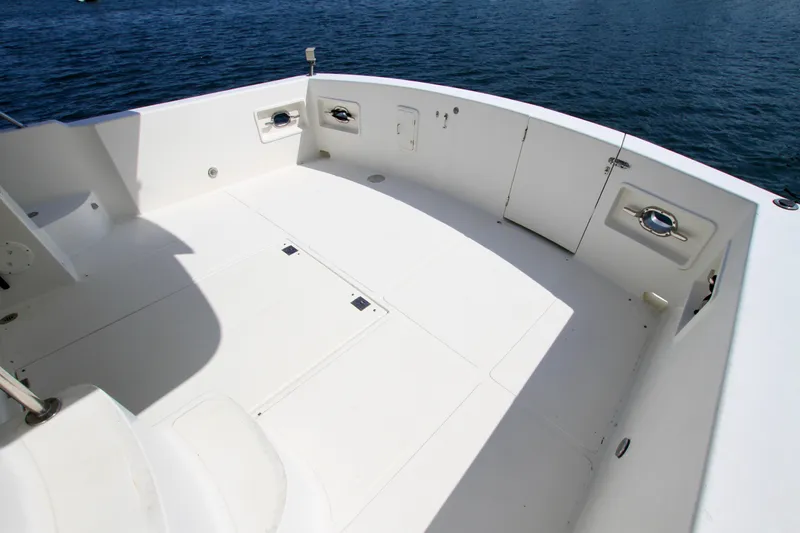 Slide: The Image of Spacious deck of 1999 McKinna 47 Sedan yacht with ocean backdrop. - 11
