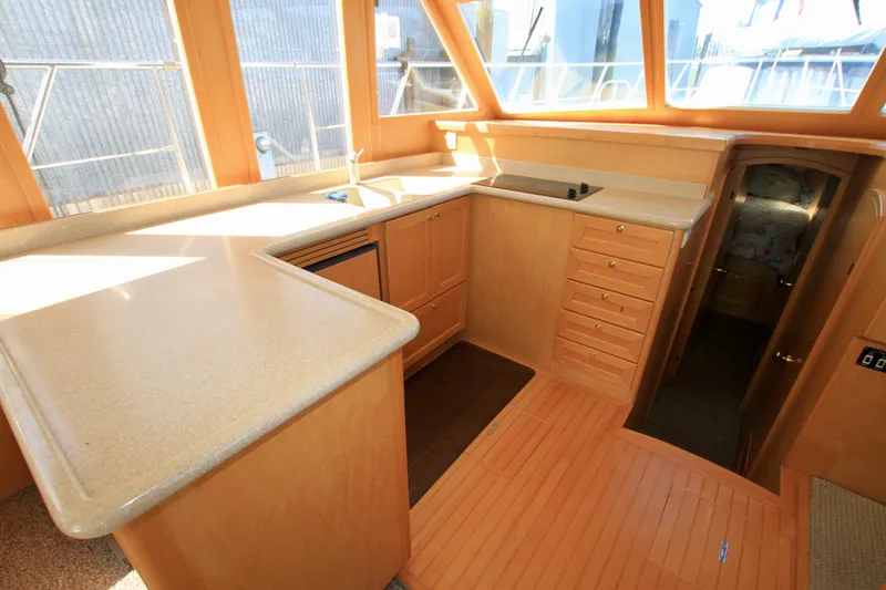 Slide: The Image of Interior of 1999 McKinna 47 Sedan yacht with modern kitchen and wooden cabinetry. - 18