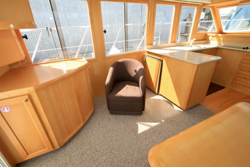 Slide: The Image of Interior of 1999 McKinna 47 Sedan yacht with modern furnishings and ample natural light. - 19
