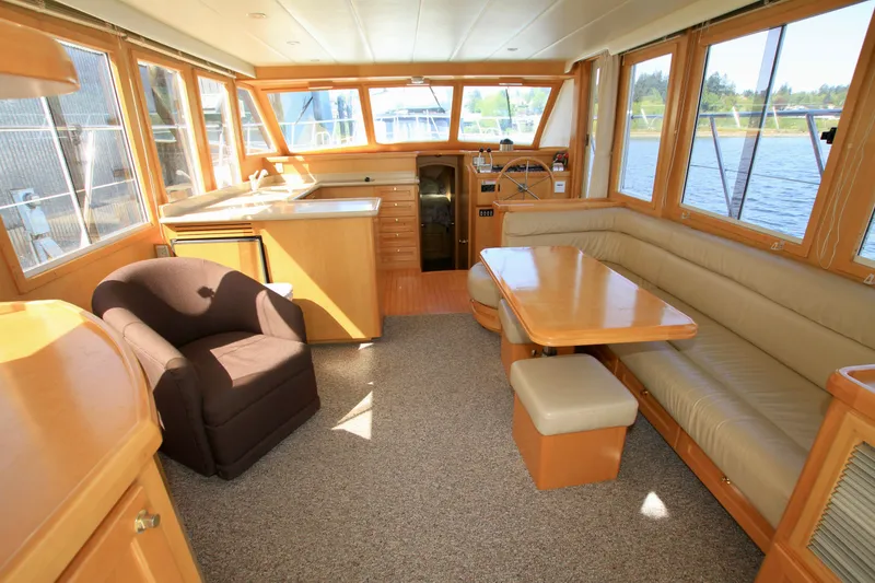 Slide: The Image of Interior of a 1999 McKinna 47 Sedan yacht with seating and dining area. - 21