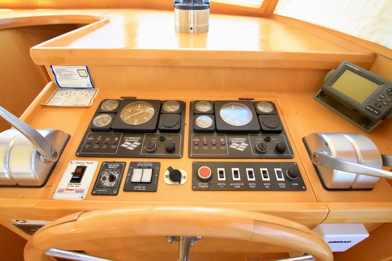 Slide: The Image of Control panel of a 1999 McKinna 47 Sedan yacht with gauges and navigation equipment. - 22