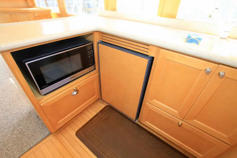 Slide: The Image of Kitchen area of 1999 McKinna 47 Sedan with microwave and cabinetry. - 25