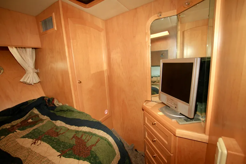 Slide: The Image of Cozy cabin interior of 1999 McKinna 47 Sedan with TV and wooden furnishings. - 28