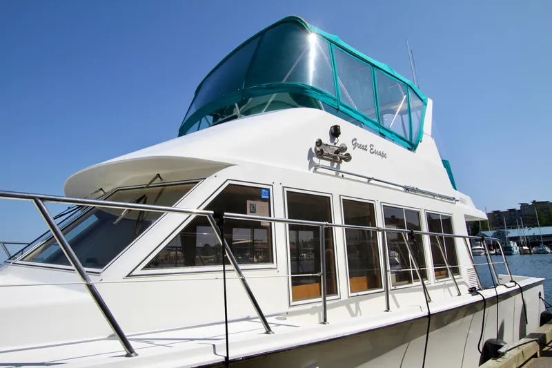 Slide: The Image of 1999 McKinna 47 Sedan yacht docked, featuring sleek design and spacious windows. - 3