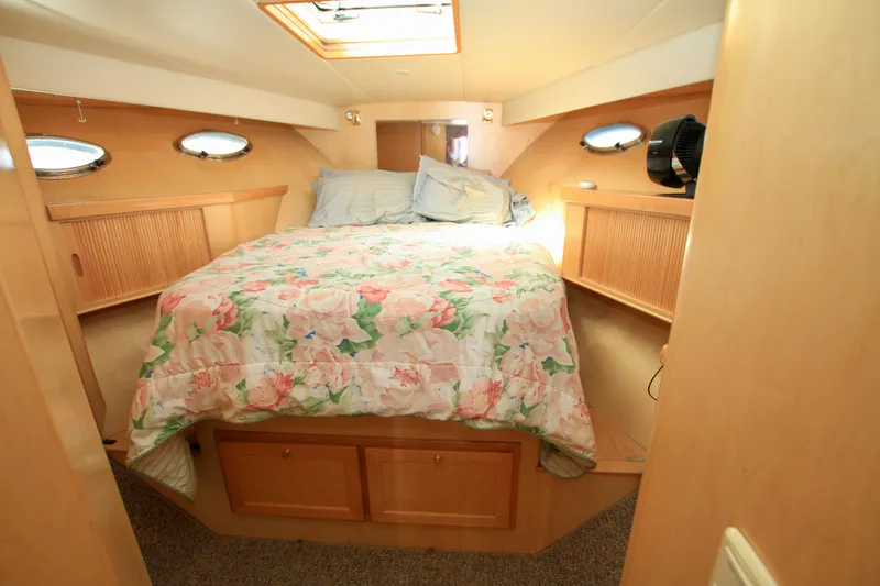 Slide: The Image of Cozy bedroom in 1999 McKinna 47 Sedan yacht with floral bedding and wood accents. - 33