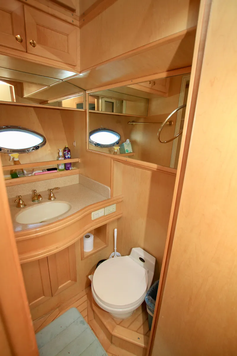 Slide: The Image of Luxurious bathroom in 1999 McKinna 47 Sedan yacht with wood cabinetry and oval mirror. - 36
