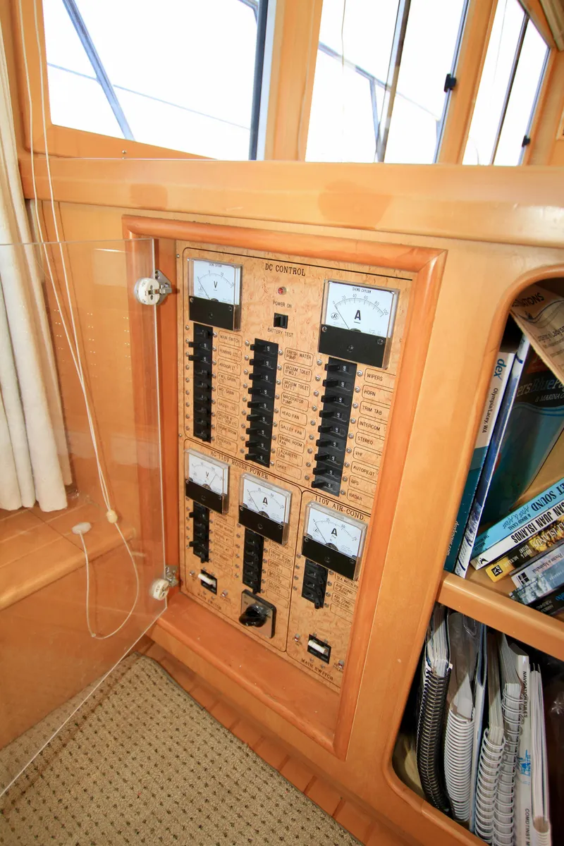 Slide: The Image of Electrical panel on a 1999 McKinna 47 Sedan yacht, featuring gauges and switches. - 37
