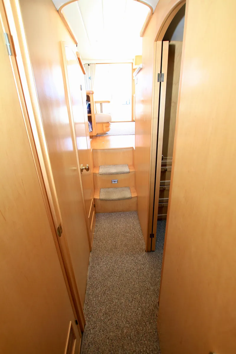Slide: The Image of Interior hallway of a 1999 McKinna 47 Sedan yacht with wooden finishes. - 38