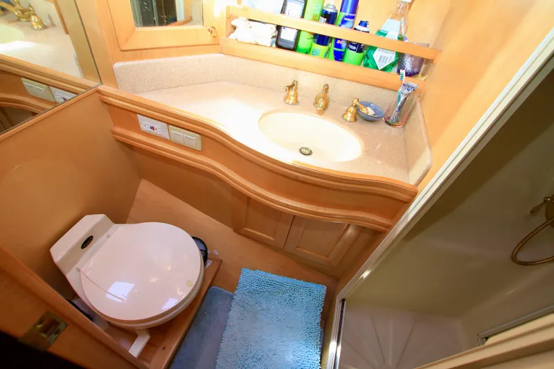 Slide: The Image of Bathroom interior of 1999 McKinna 47 Sedan yacht with sink, toilet, and shower. - 40