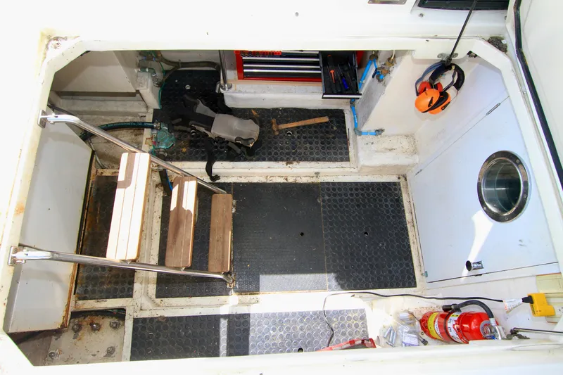 Slide: The Image of Engine room of 1999 McKinna 47 Sedan with tools, fire extinguisher, and safety equipment. - 42