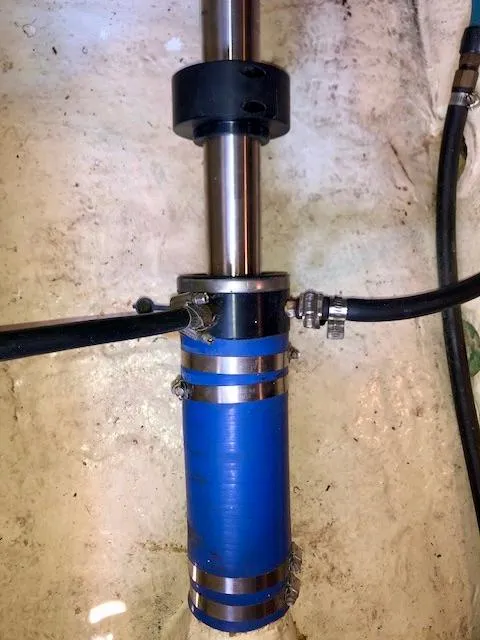 Slide: The Image of Close-up of a 1999 McKinna 47 Sedan boat's blue marine shaft seal system. - 47