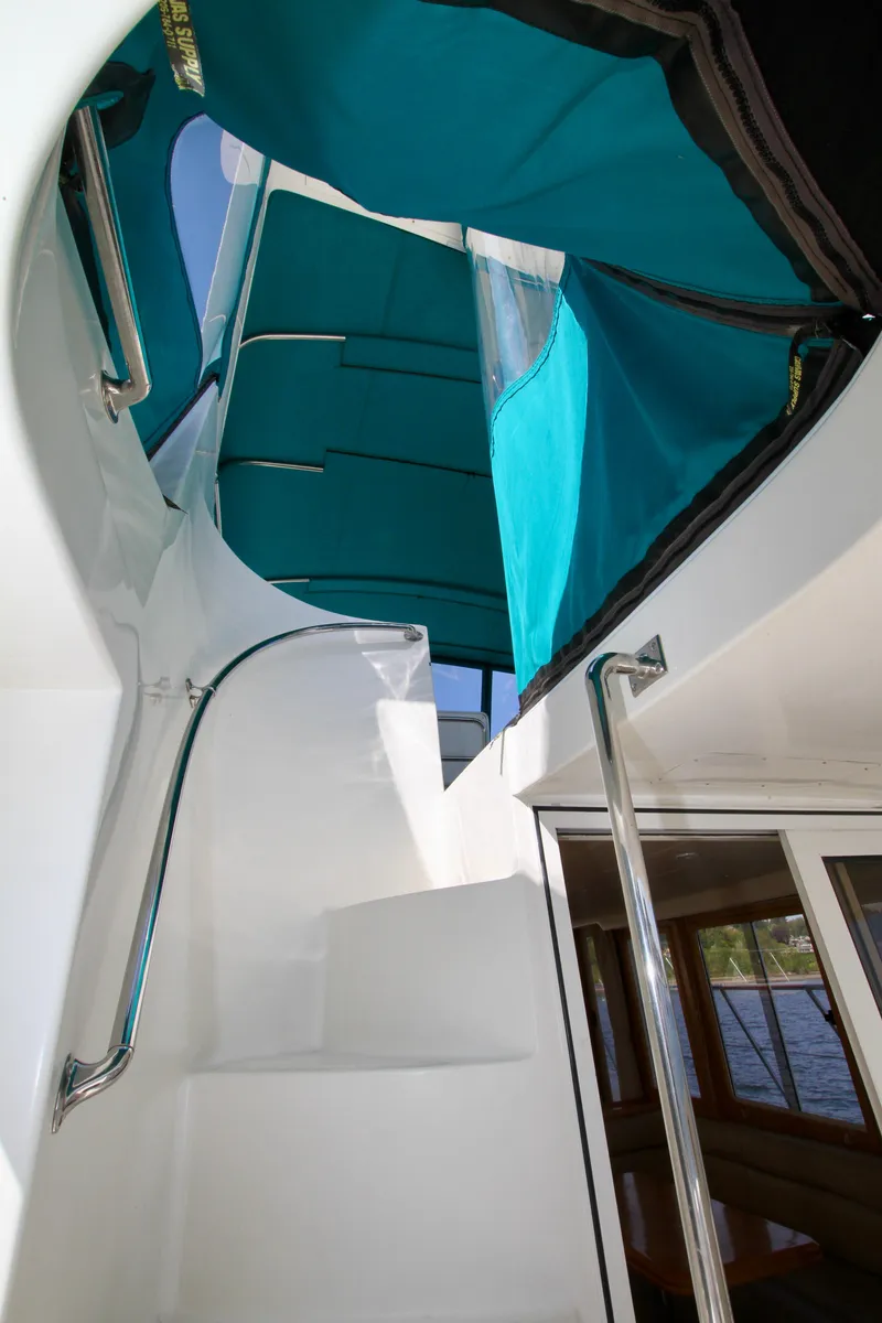 Slide: The Image of Staircase on 1999 McKinna 47 Sedan yacht with teal canopy. - 9