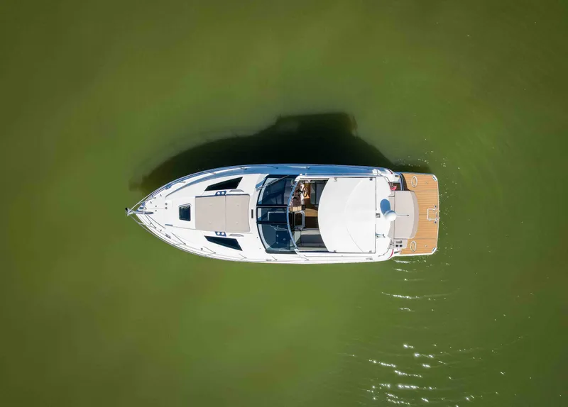 Slide: The Image of Aerial view of 2015 Regal 35 Sport Coupe boat on calm green water. - 10