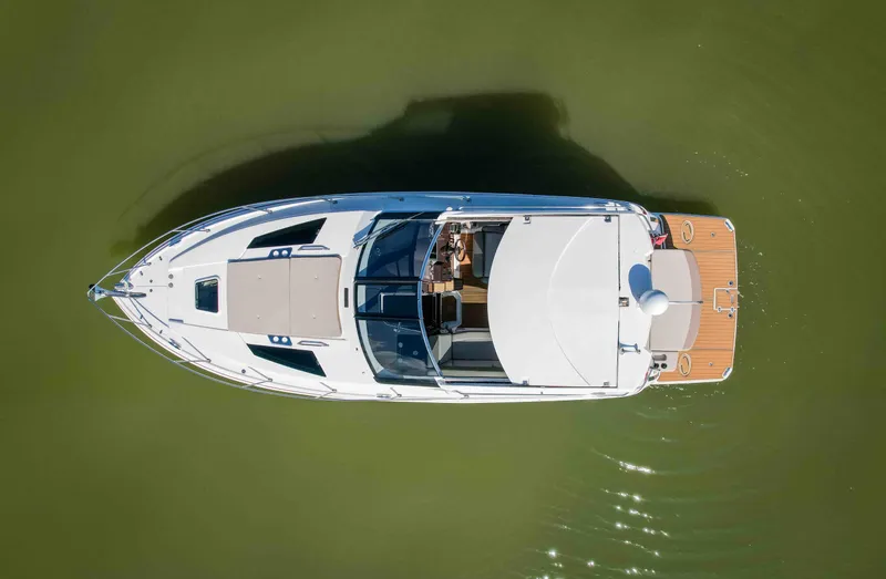 Slide: The Image of Overhead view of a 2015 Regal 35 Sport Coupe boat on calm water. - 11