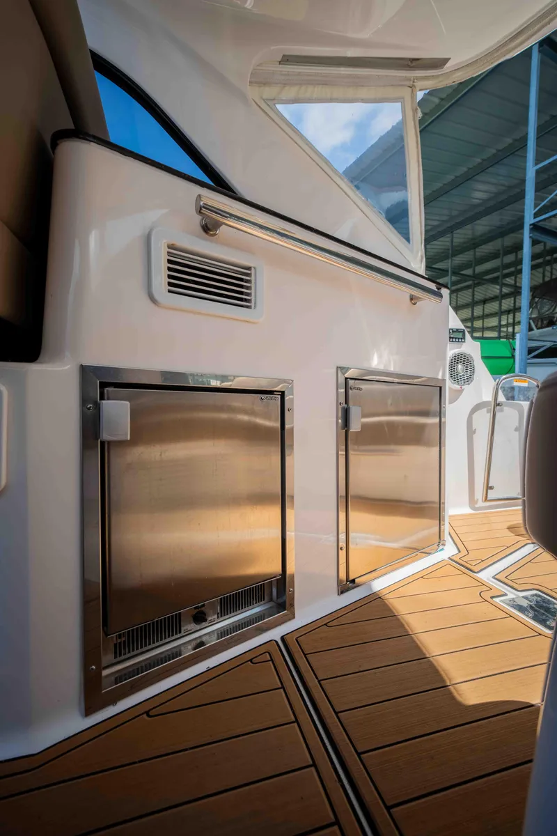 Slide: The Image of 2015 Regal 35 Sport Coupe interior with sleek stainless steel appliances and teak flooring. - 18