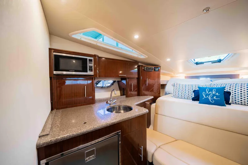 Slide: The Image of Luxurious interior of 2015 Regal 35 Sport Coupe with kitchenette and cozy seating area. - 23