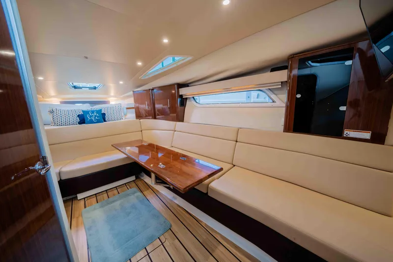 Slide: The Image of Luxurious interior of a 2015 Regal 35 Sport Coupe yacht with beige seating and wooden accents. - 27